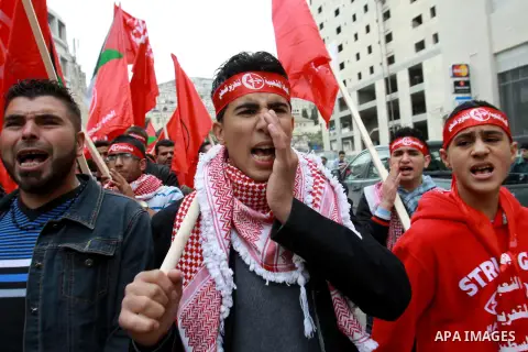 Supporters of the Popular Front for the Liberation of Palestine (PFLP) carry the party flag during a rally to mark the 45th anniversary of the establishment of the PFLP in the West Bank city of Nablus on December 8, 2012...