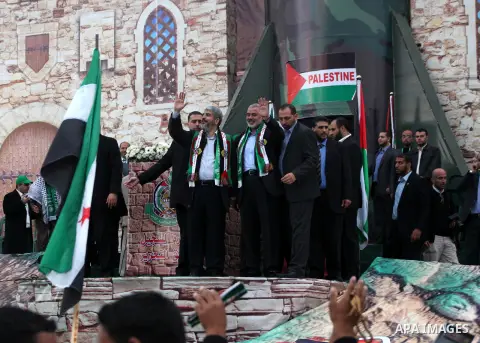 Hamas chief Khaled Meshaal, with senior Hamas leaders, takes part in a Hamas rally marking the 25th anniversary of the Islamist movement's founding in Gaza City on December 8, 2012. Meshaal arrived to Gaza strip on Decem...