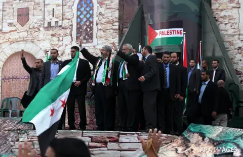 Hamas chief Khaled Meshaal, with senior Hamas leaders, takes part in a Hamas rally marking the 25th anniversary of the Islamist movement's founding in Gaza City on December 8, 2012. Meshaal arrived to Gaza strip on Decem...