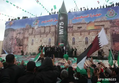 Hamas chief Khaled Meshaal, with senior Hamas leaders, takes part in a Hamas rally marking the 25th anniversary of the Islamist movement's founding in Gaza City on December 8, 2012. Meshaal arrived to Gaza strip on Decem...