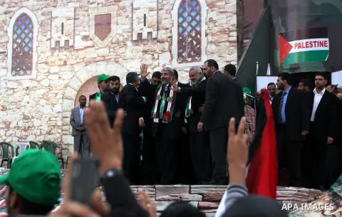 Hamas chief Khaled Meshaal, with senior Hamas leaders, takes part in a Hamas rally marking the 25th anniversary of the Islamist movement's founding in Gaza City on December 8, 2012. Meshaal arrived to Gaza strip on Decem...