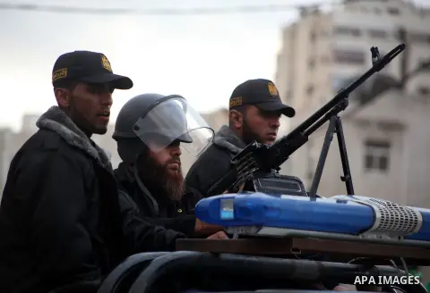 Masked Hamas security men stand guard during a Hamas rally marking the 25th anniversary of the Islamist movement's founding in Gaza City on December 8, 2012. Hamas chief Khaled Meshaal arrived to Gaza strip on December 7...
