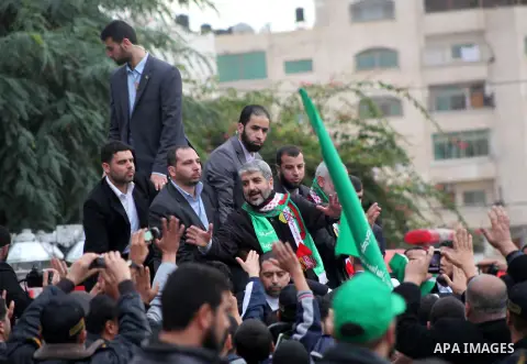Hamas chief Khaled Meshaal, with senior Hamas leaders, takes part in a Hamas rally marking the 25th anniversary of the Islamist movement's founding in Gaza City on December 8, 2012. Meshaal arrived to Gaza strip on Decem...