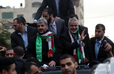 Hamas chief Khaled Meshaal, with senior Hamas leaders, takes part in a Hamas rally marking the 25th anniversary of the Islamist movement's founding in Gaza City on December 8, 2012. Meshaal arrived to Gaza strip on Decem...