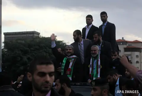 Hamas chief Khaled Meshaal, with senior Hamas leaders, takes part in a Hamas rally marking the 25th anniversary of the Islamist movement's founding in Gaza City on December 8, 2012. Meshaal arrived to Gaza strip on Decem...