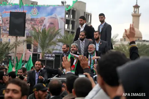 Hamas chief Khaled Meshaal, with senior Hamas leaders, takes part in a Hamas rally marking the 25th anniversary of the Islamist movement's founding in Gaza City on December 8, 2012. Meshaal arrived to Gaza strip on Decem...