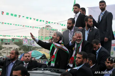 Hamas chief Khaled Meshaal, with senior Hamas leaders, takes part in a Hamas rally marking the 25th anniversary of the Islamist movement's founding in Gaza City on December 8, 2012. Meshaal arrived to Gaza strip on Decem...