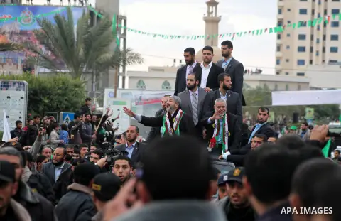 Hamas chief Khaled Meshaal, with senior Hamas leaders, takes part in a Hamas rally marking the 25th anniversary of the Islamist movement's founding in Gaza City on December 8, 2012. Meshaal arrived to Gaza strip on Decem...