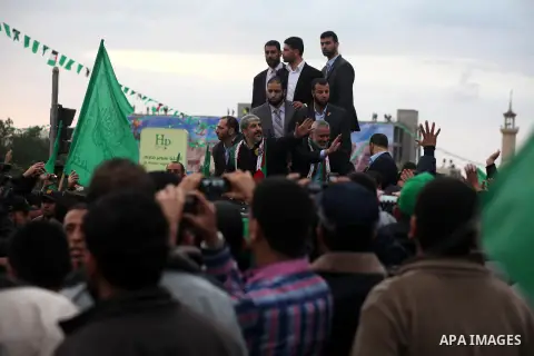 Hamas chief Khaled Meshaal, with senior Hamas leaders, takes part in a Hamas rally marking the 25th anniversary of the Islamist movement's founding in Gaza City on December 8, 2012. Meshaal arrived to Gaza strip on Decem...
