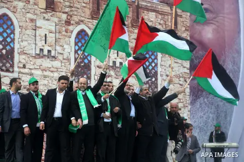 Hamas chief Khaled Meshaal, with senior Hamas leaders, takes part in a Hamas rally marking the 25th anniversary of the Islamist movement's founding in Gaza City on December 8, 2012. Meshaal arrived to Gaza strip on Decem...