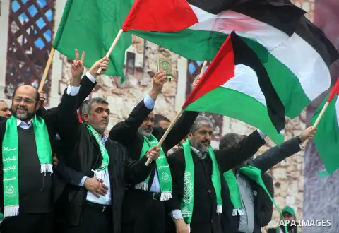 Hamas chief Khaled Meshaal, with senior Hamas leaders, takes part in a Hamas rally marking the 25th anniversary of the Islamist movement's founding in Gaza City on December 8, 2012. Meshaal arrived to Gaza strip on Decem...