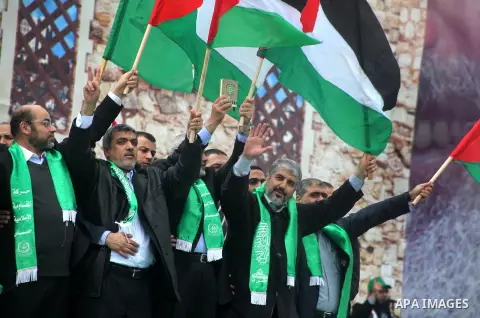 Hamas chief Khaled Meshaal, with senior Hamas leaders, takes part in a Hamas rally marking the 25th anniversary of the Islamist movement's founding in Gaza City on December 8, 2012. Meshaal arrived to Gaza strip on Decem...