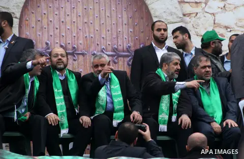 Hamas chief Khaled Meshaal, with senior Hamas leaders, takes part in a Hamas rally marking the 25th anniversary of the Islamist movement's founding in Gaza City on December 8, 2012. Meshaal arrived to Gaza strip on Decem...