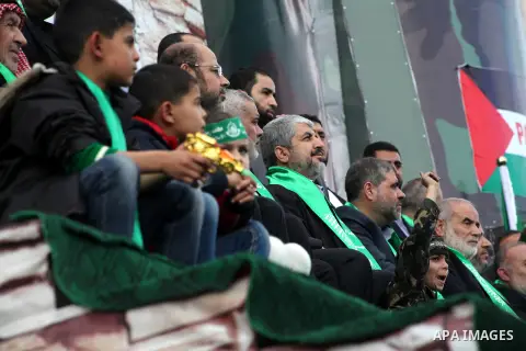 Hamas chief Khaled Meshaal, with senior Hamas leaders, takes part in a Hamas rally marking the 25th anniversary of the Islamist movement's founding in Gaza City on December 8, 2012. Meshaal arrived to Gaza strip on Decem...
