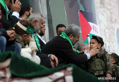 Hamas chief Khaled Meshaal, with senior Hamas leaders, takes part in a Hamas rally marking the 25th anniversary of the Islamist movement's founding in Gaza City on December 8, 2012. Meshaal arrived to Gaza strip on Decem...