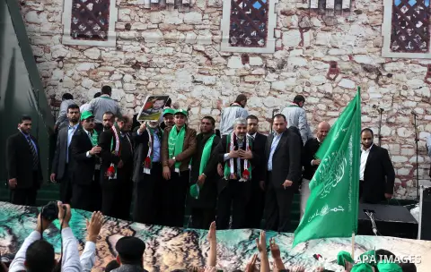 Hamas chief Khaled Meshaal, with senior Hamas leaders, takes part in a Hamas rally marking the 25th anniversary of the Islamist movement's founding in Gaza City on December 8, 2012. Meshaal arrived to Gaza strip on Decem...