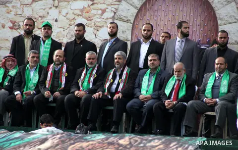 Hamas chief Khaled Meshaal, with senior Hamas leaders, takes part in a Hamas rally marking the 25th anniversary of the Islamist movement's founding in Gaza City on December 8, 2012. Meshaal arrived to Gaza strip on Decem...