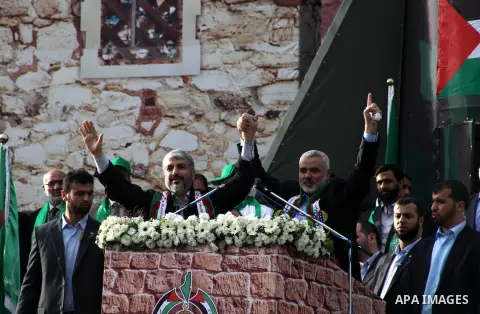Hamas chief Khaled Meshaal, with senior Hamas leaders, takes part in a Hamas rally marking the 25th anniversary of the Islamist movement's founding in Gaza City on December 8, 2012. Meshaal arrived to Gaza strip on Decem...
