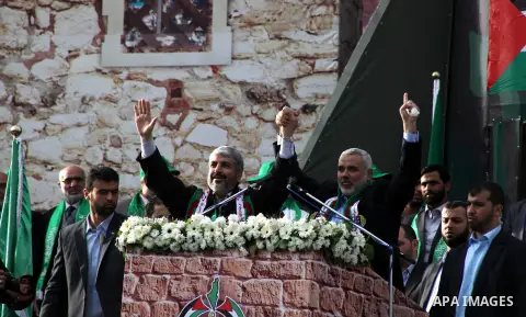 Hamas chief Khaled Meshaal, with senior Hamas leaders, takes part in a Hamas rally marking the 25th anniversary of the Islamist movement's founding in Gaza City on December 8, 2012. Meshaal arrived to Gaza strip on Decem...
