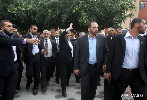 Hamas chief Khaled Meshaal, is greeted during his visit to the Islamic University in Gaza City December 9, 2012. Meshaal, in a defiant speech during his first ever visit to Gaza, told a mass rally on Saturday he would ne...