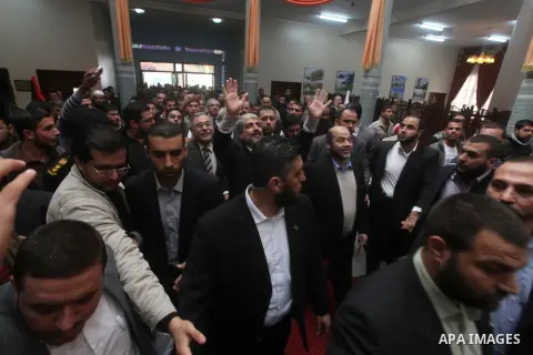 Hamas chief Khaled Meshaal, is greeted during his visit to the Islamic University in Gaza City December 9, 2012. Meshaal, in a defiant speech during his first ever visit to Gaza, told a mass rally on Saturday he would ne...