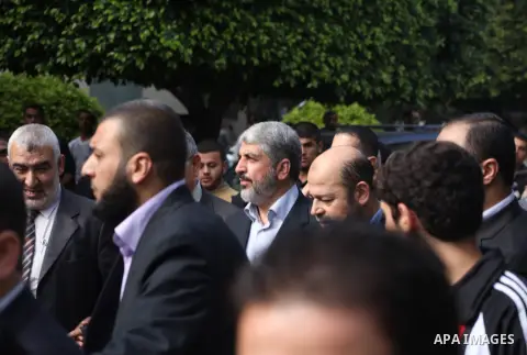Hamas chief Khaled Meshaal, is greeted during his visit to the Islamic University in Gaza City December 9, 2012. Meshaal, in a defiant speech during his first ever visit to Gaza, told a mass rally on Saturday he would ne...