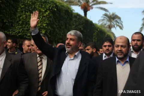 Hamas chief Khaled Meshaal, is greeted during his visit to the Islamic University in Gaza City December 9, 2012. Meshaal, in a defiant speech during his first ever visit to Gaza, told a mass rally on Saturday he would ne...