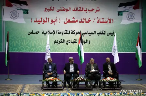 Hamas chief in exile Khaled Meshaal, waves at supporters during a visit to the Islamic University in Gaza City on December 9, 2012. Meshaal rejected ceding "an inch" of Palestinian territory to Israel or recognising the...