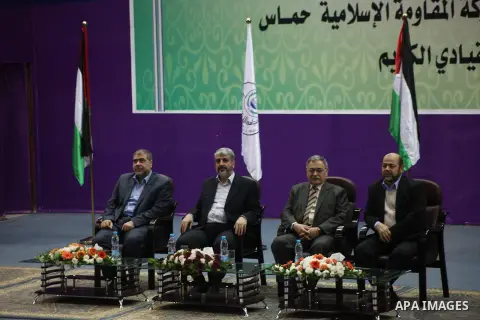 Hamas chief in exile Khaled Meshaal, waves at supporters during a visit to the Islamic University in Gaza City on December 9, 2012. Meshaal rejected ceding "an inch" of Palestinian territory to Israel or recognising the...