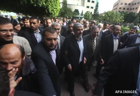 Hamas chief Khaled Meshaal, is greeted during his visit to the Islamic University in Gaza City December 9, 2012. Meshaal, in a defiant speech during his first ever visit to Gaza, told a mass rally on Saturday he would ne...