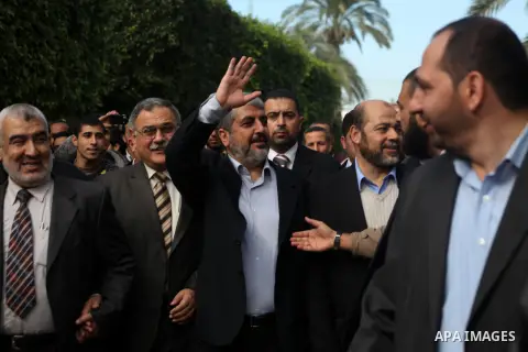 Hamas chief in exile Khaled Meshaal, waves at supporters during a visit to the Islamic University in Gaza City on December 9, 2012. Meshaal rejected ceding "an inch" of Palestinian territory to Israel or recognising the...