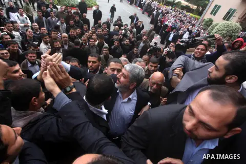 Hamas chief in exile Khaled Meshaal, waves at supporters during a visit to the Islamic University in Gaza City on December 9, 2012. Meshaal rejected ceding "an inch" of Palestinian territory to Israel or recognising the...