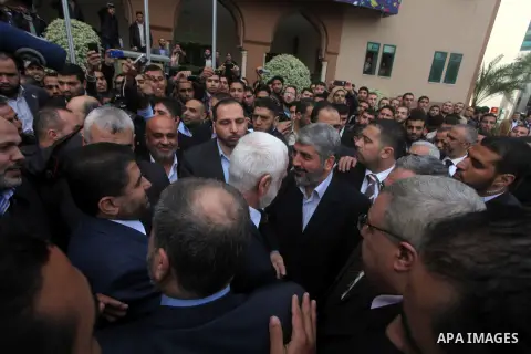 Hamas chief in exile Khaled Meshaal, waves at supporters during a visit to the Islamic University in Gaza City on December 9, 2012. Meshaal rejected ceding "an inch" of Palestinian territory to Israel or recognising the...