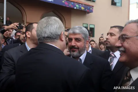 Hamas chief in exile Khaled Meshaal, waves at supporters during a visit to the Islamic University in Gaza City on December 9, 2012. Meshaal rejected ceding "an inch" of Palestinian territory to Israel or recognising the...