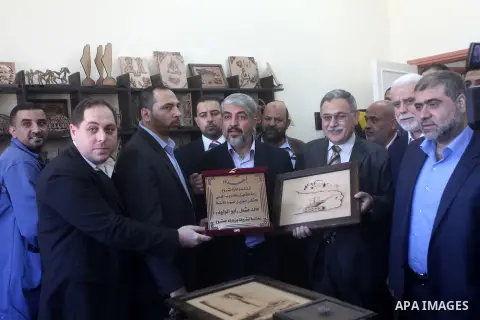 Hamas chief Khaled Meshaal, is greeted during his visit to a project funded by the Turkish President ragab ardogan in the Islamic University in Gaza City December 9, 2012. Meshaal, in a defiant speech during his first ev...