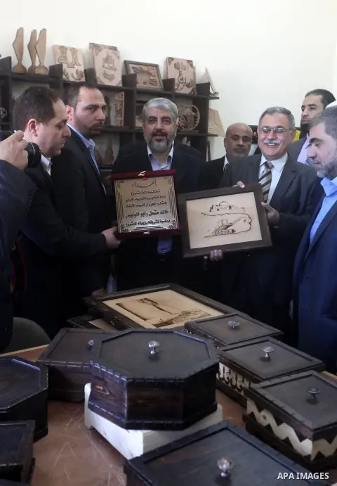 Hamas chief Khaled Meshaal, is greeted during his visit to a project funded by the Turkish President ragab ardogan in the Islamic University in Gaza City December 9, 2012. Meshaal, in a defiant speech during his first ev...