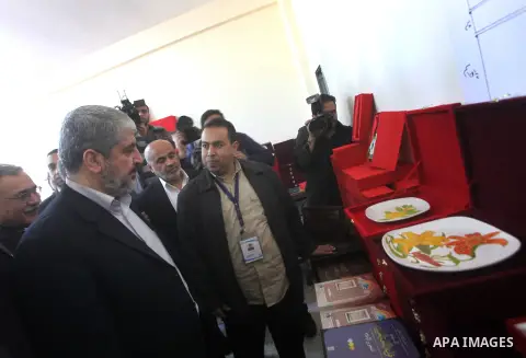Hamas chief Khaled Meshaal, is greeted during his visit to a project funded by the Turkish President ragab ardogan in the Islamic University in Gaza City December 9, 2012. Meshaal, in a defiant speech during his first ev...