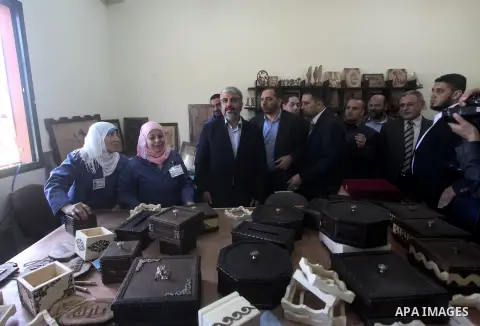 Hamas chief Khaled Meshaal, is greeted during his visit to a project funded by the Turkish President ragab ardogan in the Islamic University in Gaza City December 9, 2012. Meshaal, in a defiant speech during his first ev...