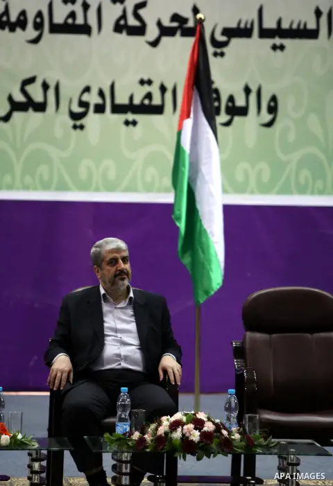 Hamas chief in exile Khaled Meshaal, waves at supporters during a visit to the Islamic University in Gaza City on December 9, 2012. Meshaal rejected ceding "an inch" of Palestinian territory to Israel or recognising the...