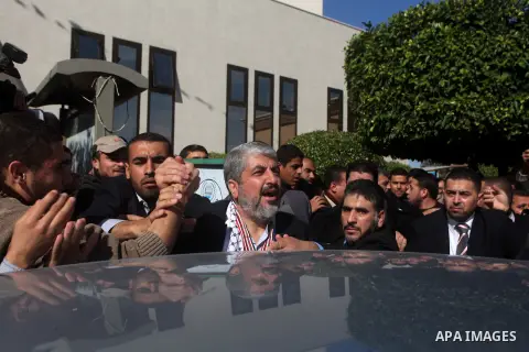 Hamas chief in exile Khaled Meshaal, waves at supporters during a visit to the Islamic University in Gaza City on December 9, 2012. Meshaal rejected ceding "an inch" of Palestinian territory to Israel or recognising the...