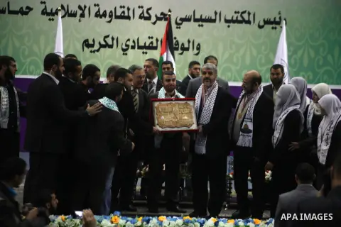 Hamas chief in exile Khaled Meshaal, waves at supporters during a visit to the Islamic University in Gaza City on December 9, 2012. Meshaal rejected ceding "an inch" of Palestinian territory to Israel or recognising the...