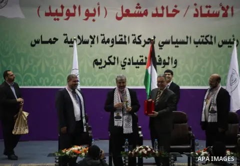 Hamas chief in exile Khaled Meshaal, waves at supporters during a visit to the Islamic University in Gaza City on December 9, 2012. Meshaal rejected ceding "an inch" of Palestinian territory to Israel or recognising the...
