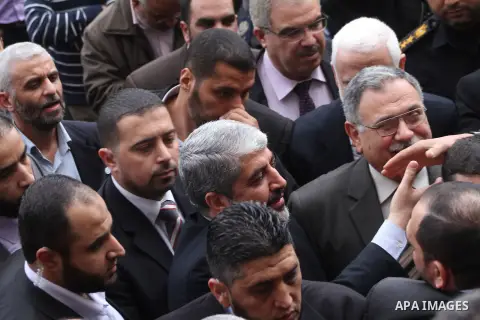 Hamas chief in exile Khaled Meshaal, waves at supporters during a visit to the Islamic University in Gaza City on December 9, 2012. Meshaal rejected ceding "an inch" of Palestinian territory to Israel or recognising the...