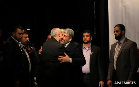 Hamas chief Khaled Meshaal attends a ceremony with Greek Orthodox Archbishop Alexios and senior Muslim cleric Hassan Al-Jojo in Gaza City December 9, 2012. Meshaal, in a defiant speech during his first ever visit to Gaza...