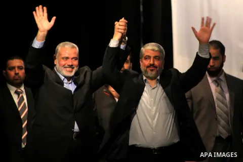 Hamas chief Khaled Meshaal attends a ceremony with Greek Orthodox Archbishop Alexios and senior Muslim cleric Hassan Al-Jojo in Gaza City December 9, 2012. Meshaal, in a defiant speech during his first ever visit to Gaza...