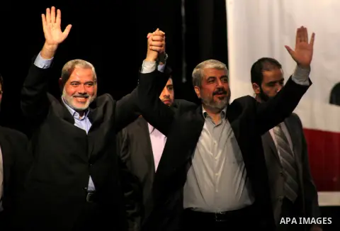 Hamas chief Khaled Meshaal attends a ceremony with Greek Orthodox Archbishop Alexios and senior Muslim cleric Hassan Al-Jojo in Gaza City December 9, 2012. Meshaal, in a defiant speech during his first ever visit to Gaza...