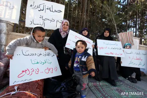 Palestinian teachers and graduates who were barred from employment by Ministry of Education, hold placards during a protest in front of Council of Ministers, in the West Bank city of Ramallah, December 09, 2012 . Photo b...