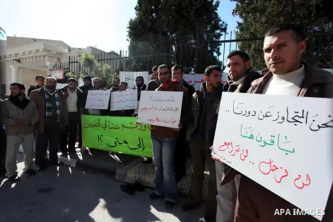 Palestinian teachers and graduates who were barred from employment by Ministry of Education, hold placards during a protest in front of Council of Ministers, in the West Bank city of Ramallah, December 09, 2012 . Photo b...