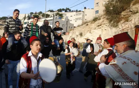 Palestinians celebrate after the Israeli authorities released prisoner Obaida al-Tawil in neighborhood of Bab al- Amood in Jerusalem on December 9, 2012. Al-Tawil spent 2 years in prison before the Israeli authorities re...