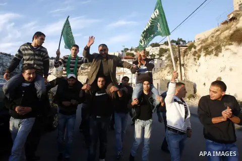 Palestinians celebrate after the Israeli authorities released prisoner Obaida al-Tawil in neighborhood of Bab al- Amood in Jerusalem on December 9, 2012. Al-Tawil spent 2 years in prison before the Israeli authorities re...